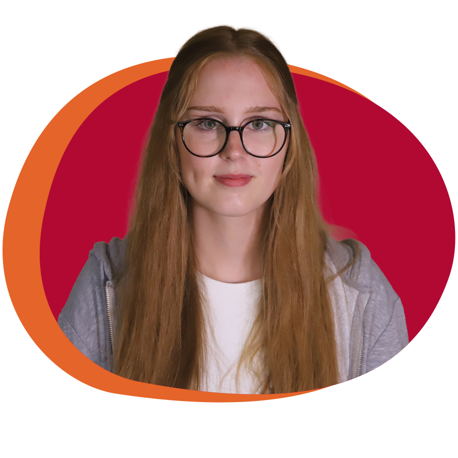 Junge Frau mit Brille und glatten, blonden und langen Haaren blickt freundlich in die Kamera.